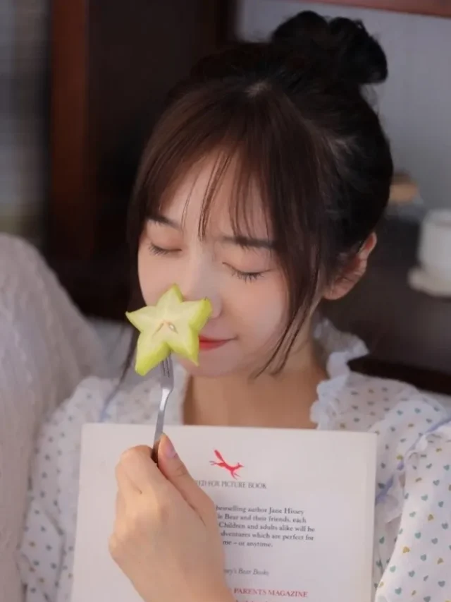 beautiful girl eating star fruit