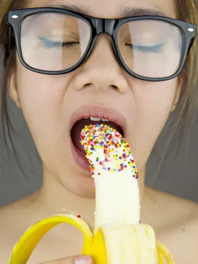 Beautiful woman with black sunglasses sexy eating banana 5 Benefits of Bananas According to Science